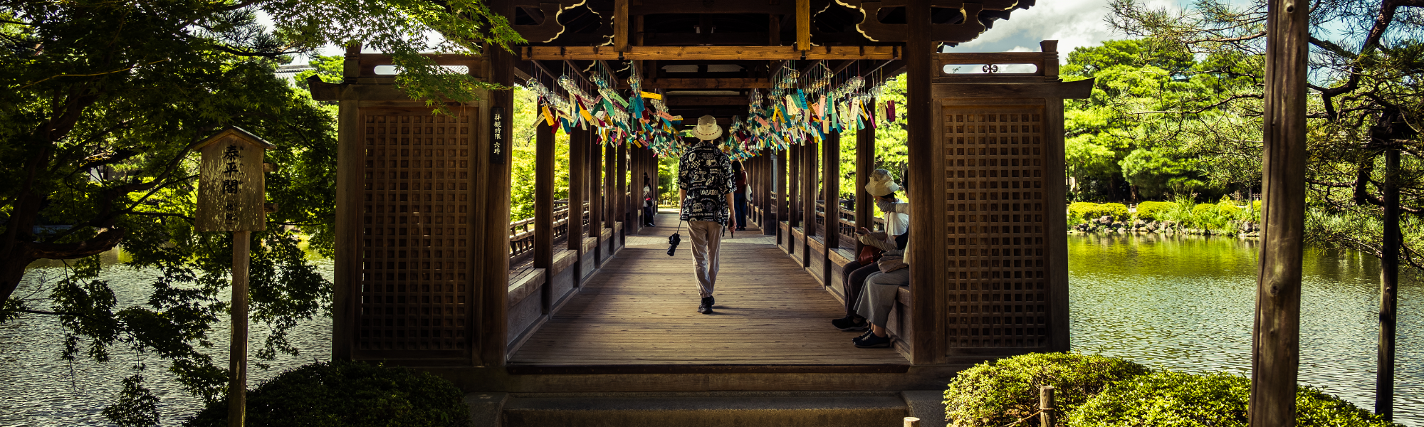 Heian Shrine in Kyoto, Japan. wind chimes carry the wishes of countless people, and a person in the center of the frame passes through it all calmly