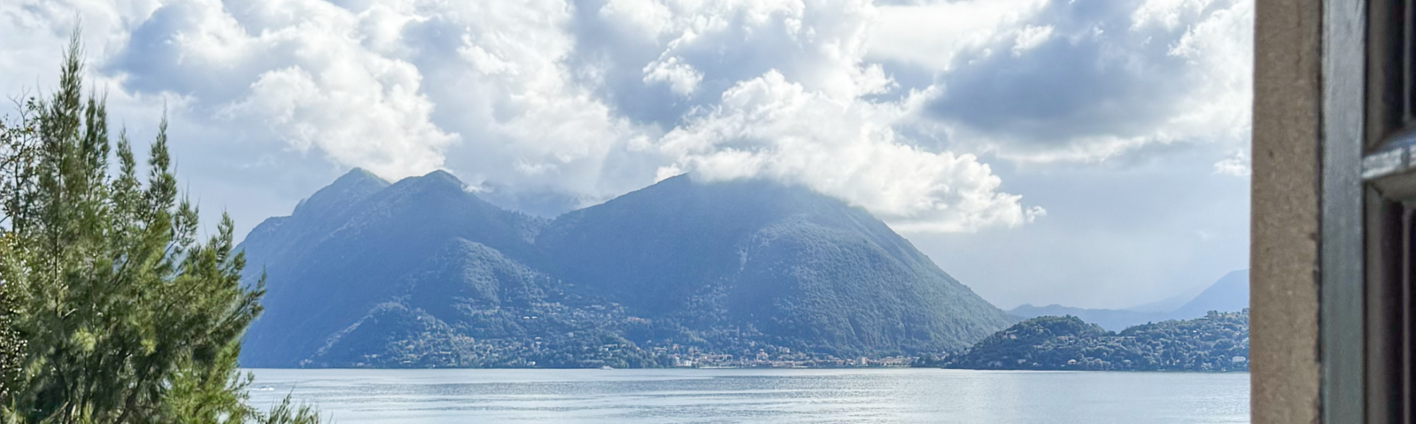 Isola Madre, Lake Maggiore, Italy; Looking through a window to see a chapel by a lake