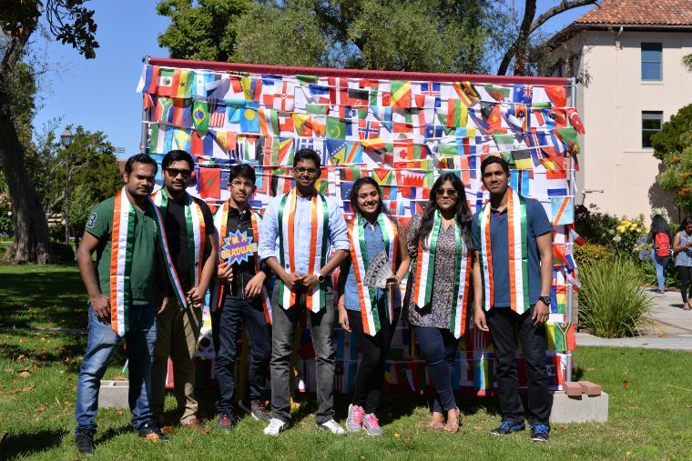 International Students with stoles of their country flags celebrating graduation
