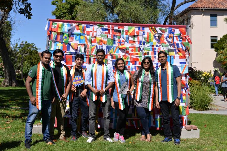 International Students with stoles of their country flags celebrating graduation