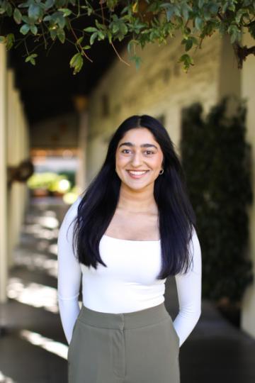 Meenu standing near Adobe Lodge
