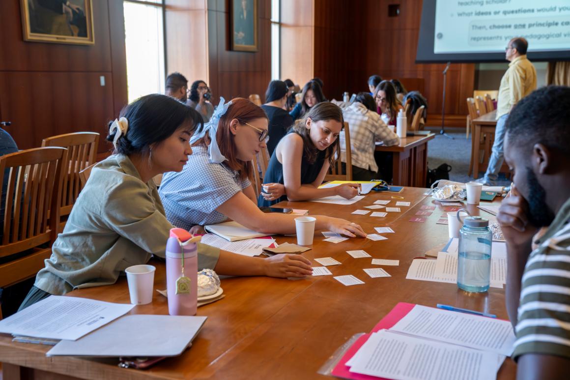 4 faculty working at tables