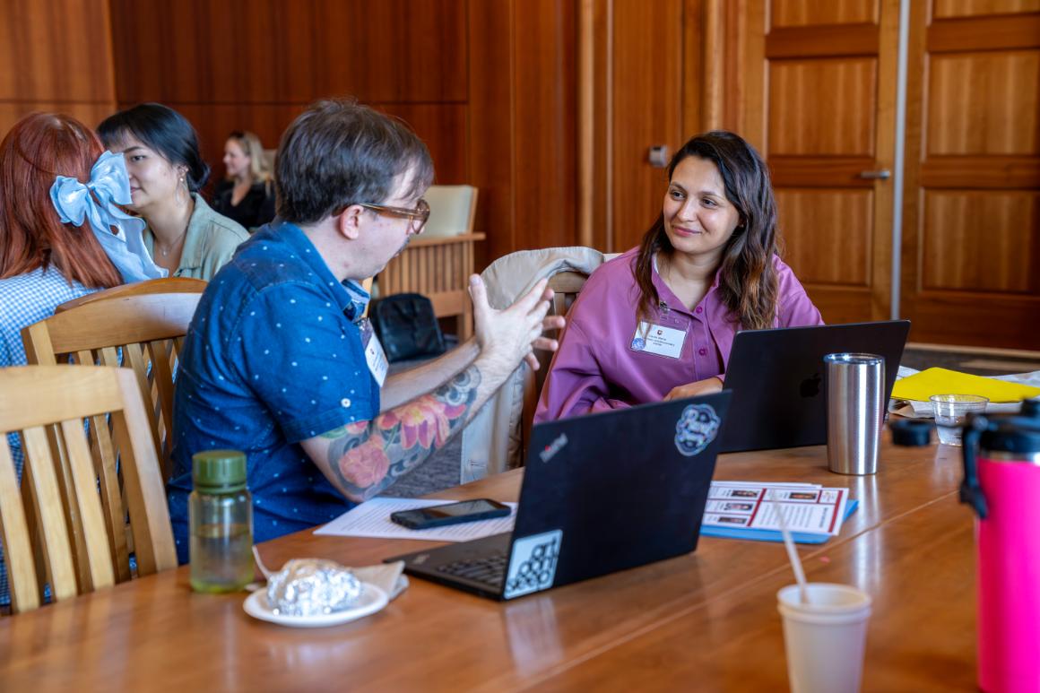 two faculty talking animatedly