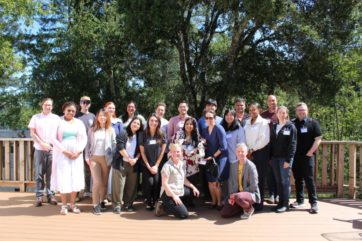 faculty standing on deck in the sun posing for group photo