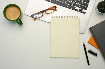 laptop, writing pad, glasses