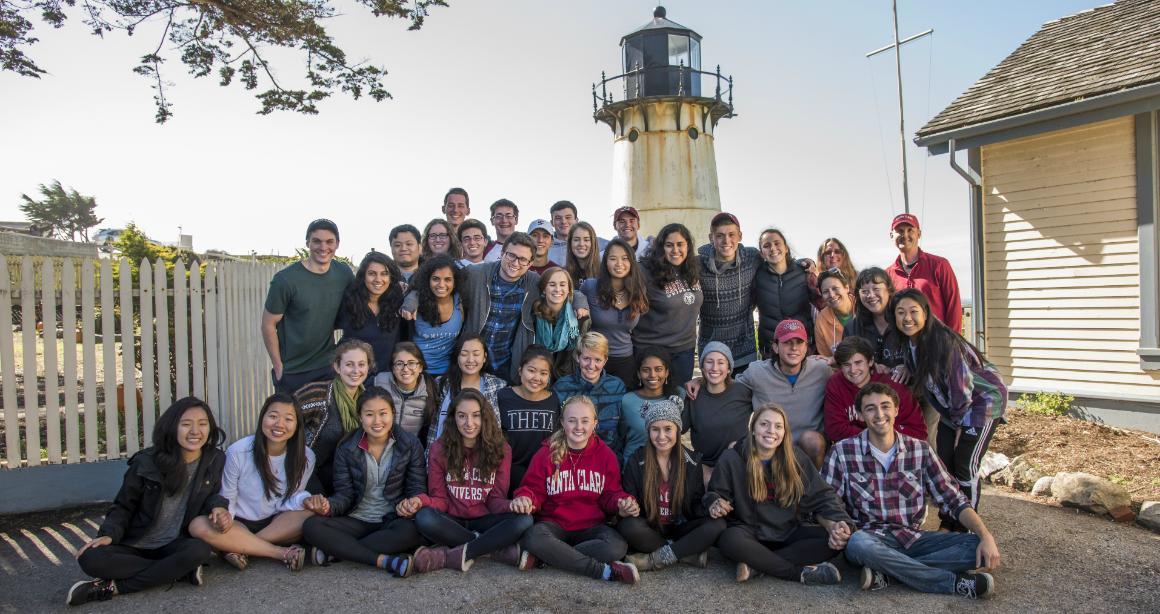 A group of people posing for a photo at a retreat.