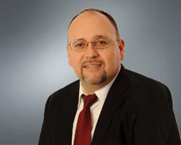 A man in a suit and red tie. image link to story