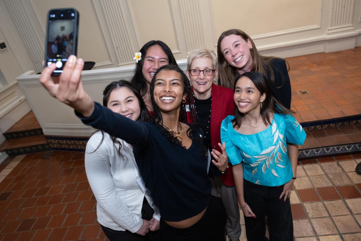 A group of smiling SCU students taking a selfie with SCUs President. image link to story