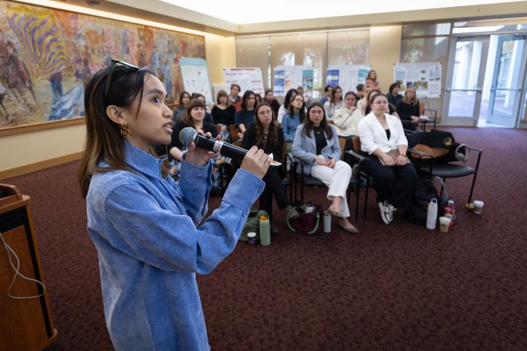 A student researcher speaking at the 2025 Sustainability Symposium session
