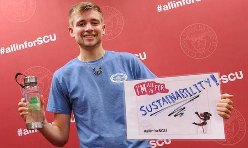 A person holds a sign reading ALL IN FOR SCU against a red background.