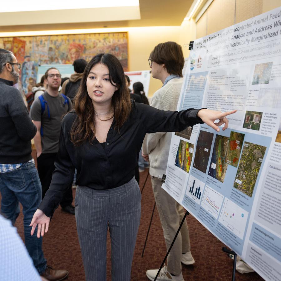 Student pointing at a poster