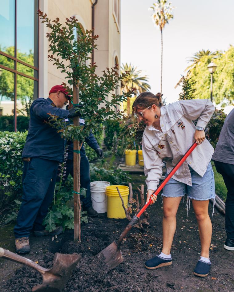 Arbor Day 2026: Student with shovel planting a tree next to a Facilities employee
