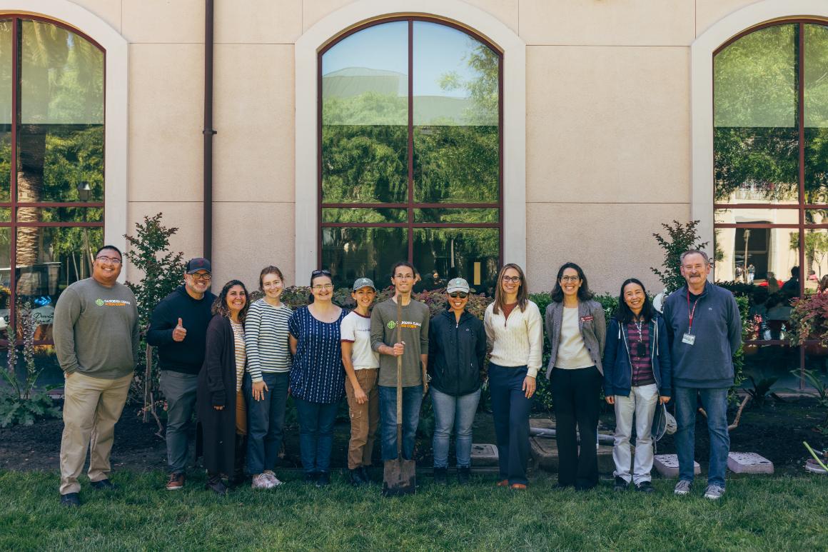 Arbor Day 2026: Group standing in front of recently planting trees in front of Graham