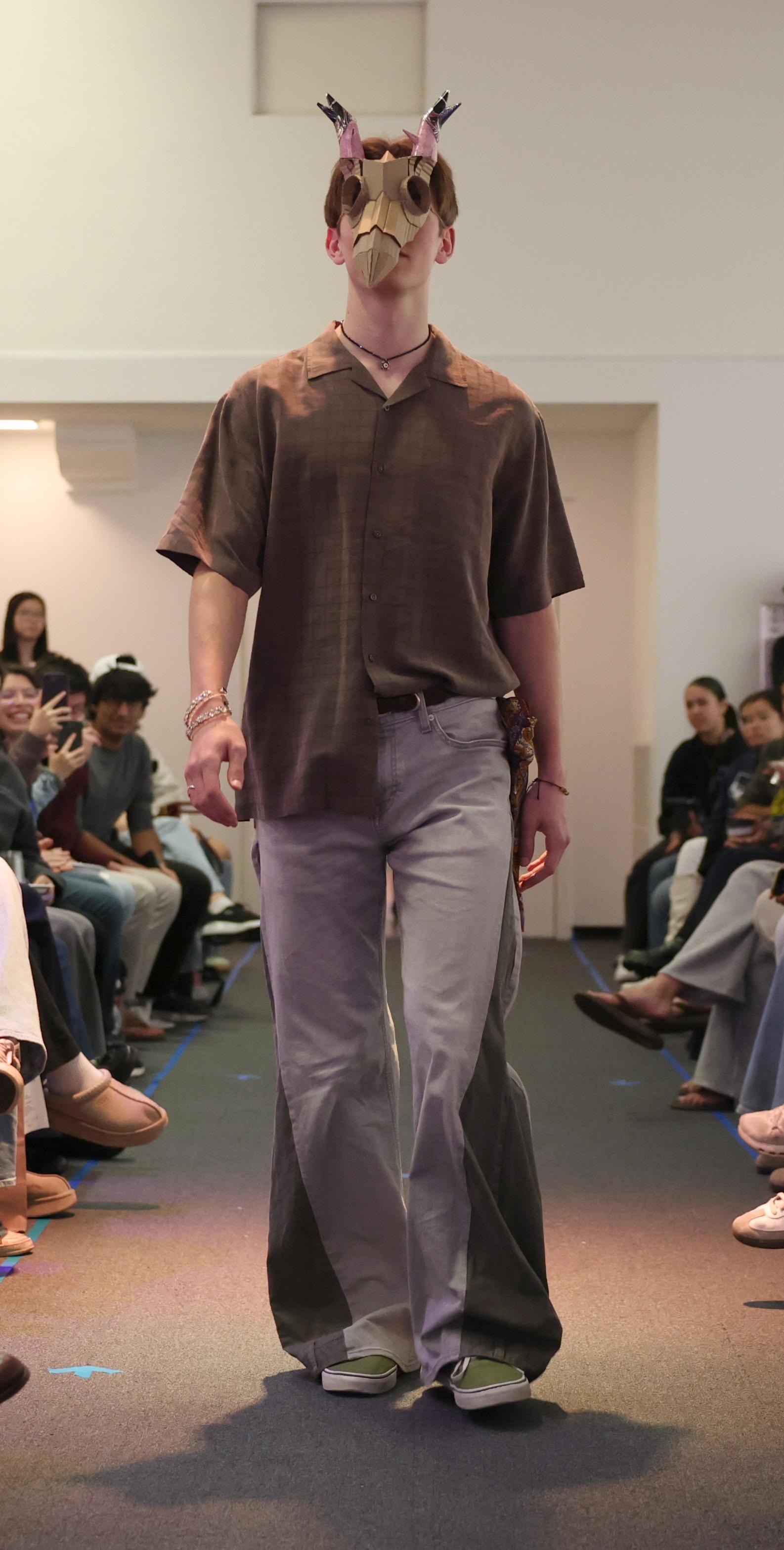 EcoFashion Show 2026 Model on runaway wearing a deer mask and antlers