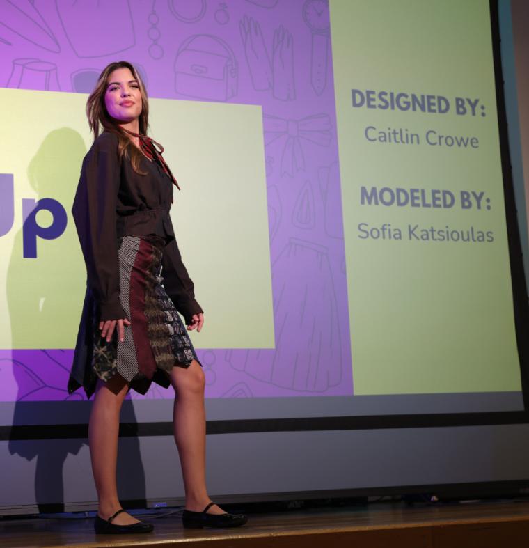 EcoFashion Show 2026: Model posing on stage wearing a outfit made of ties