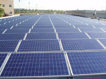 Solar panels installed on a rooftop under a clear sky.