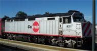 Passenger train at a station platform with Caltrain on the side.