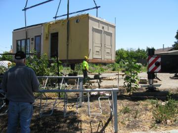 The solar house being lowered into place by a large crane at the forge garden