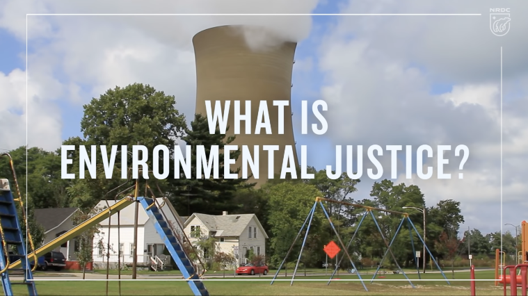The title What is Environmental Justice? written over a photo of a childrens playground with a large smokestack looming behind it