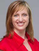 A person smiling and wearing a red shirt.