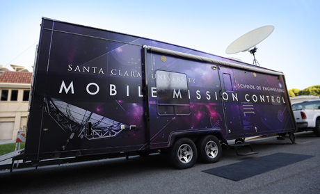 A large trailer labeled NASAs Mobile Mission Control parked on a street.