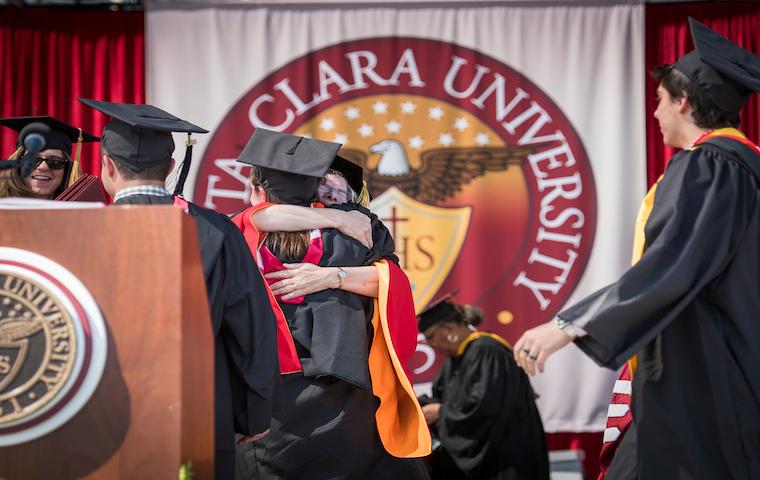 Graduates on stage during USC Aiken Universitys 2016 commencement ceremony. image link to story