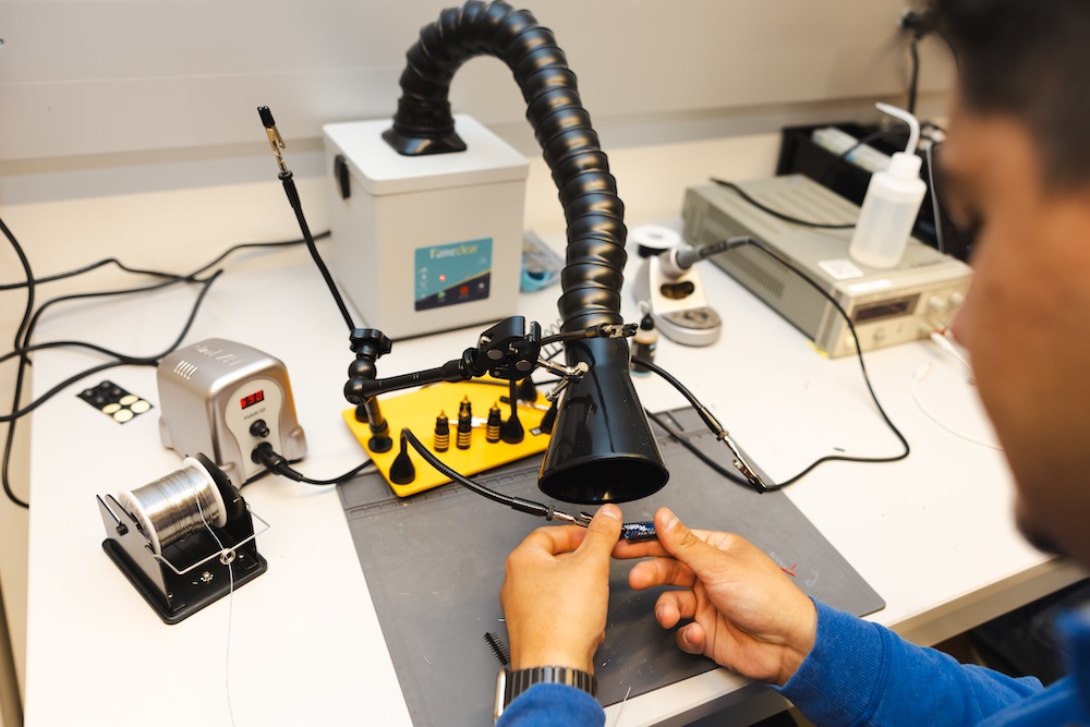 Engineering students hands holding a small transistor