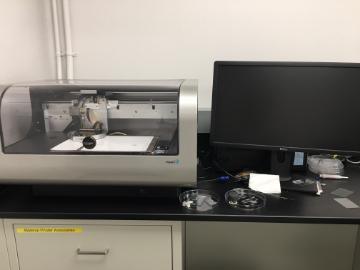 Dimatix Materials Printer DMP-2800 next to a monitor on a lab bench.