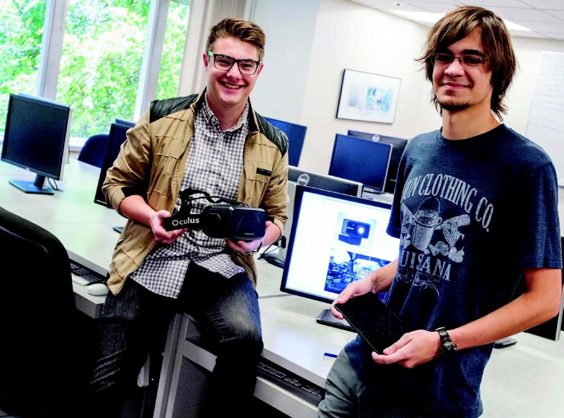 Bryce Mariano, left, and Paul Thurston show off the Oculus Rift and tablet that therapists employing their software can use to allay patients fears.