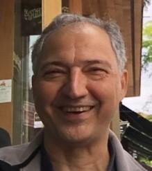 A person smiling in a casual setting.