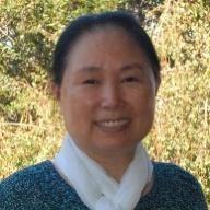 A woman named Weijia Shang smiling outdoors.