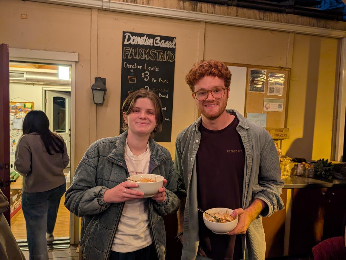 Students who are holding food at the Forge Garden