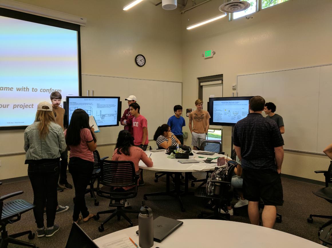 Students presenting posters in classroom during Poster Presentation (ENGR 1L) session.