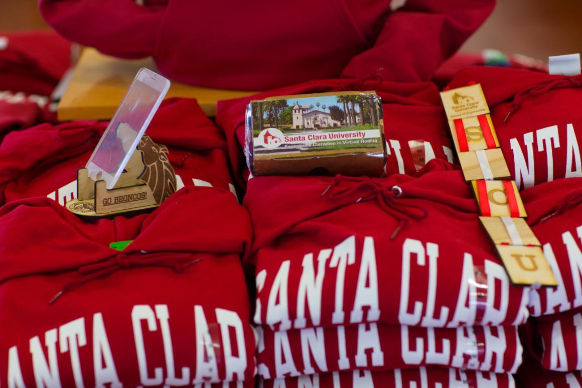 Red clothing with Santa Clara text and various small bookstore items displayed.