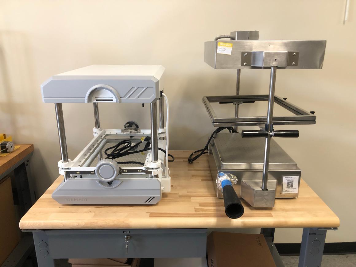 Two vacuum formers on a table