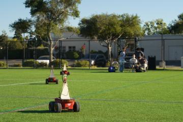 Students testing adaptive navigation techniques using Pioneer land robots