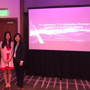 Two people in front of a screen displaying ANT+ Symposia 2014. image link to story
