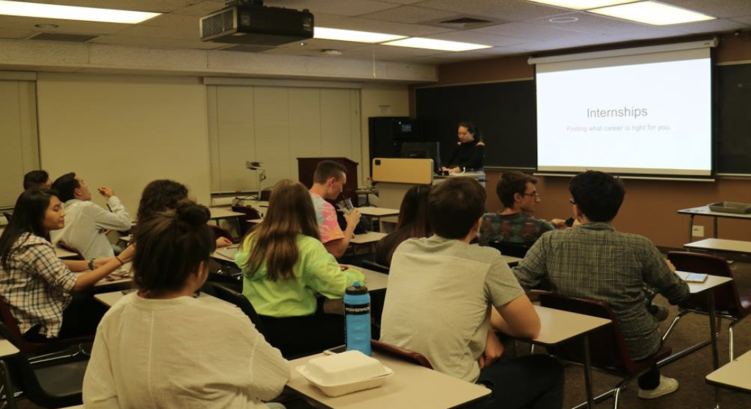 Students in classroom attending a Theta Tau Resume presentation on a screen.