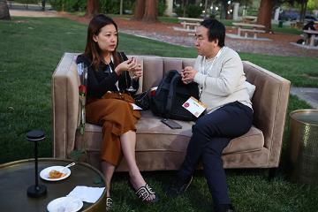 Woman and a man talking at Demo Day 2025 event