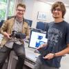 Bryce Mariano, left, and Paul Thurston show off the Oculus Rift and tablet that therapists employing their software can use to allay patients fears.